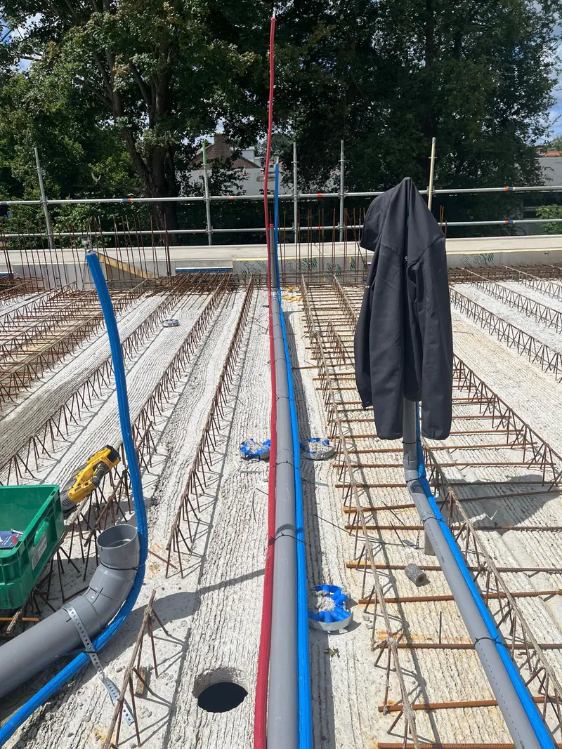 Blauwe leidingen en afvoer tussen de wapening